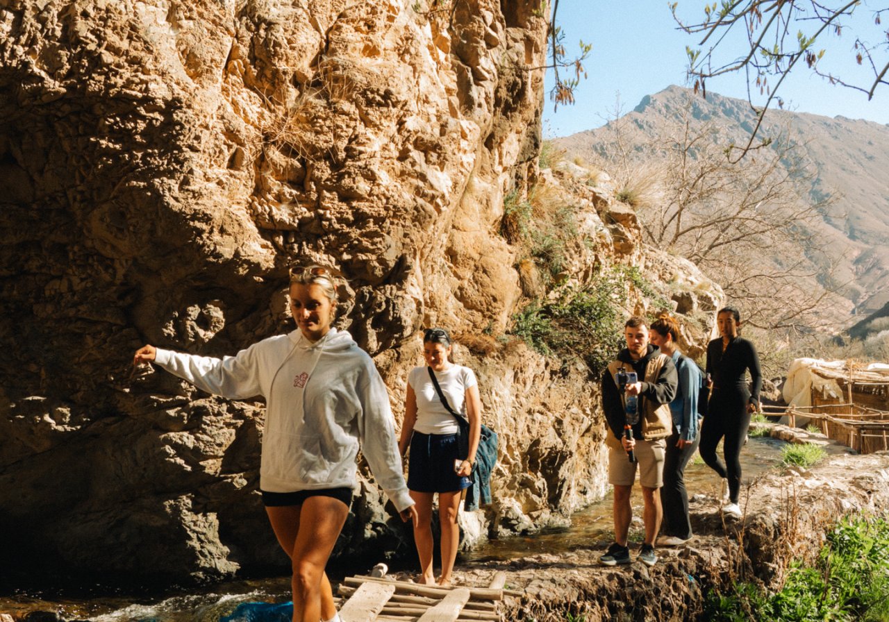 A group of travellers in Morocco trek to a waterfall just outside of Imlil 